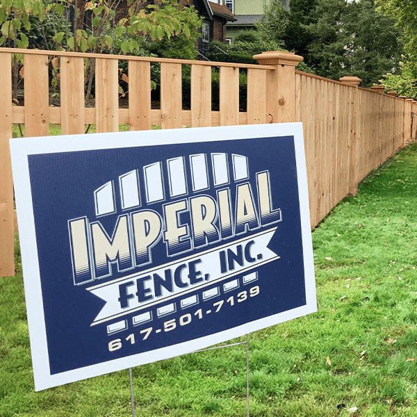 Imperial Fence estimator measuring a residential property line in Tewksbury, MA