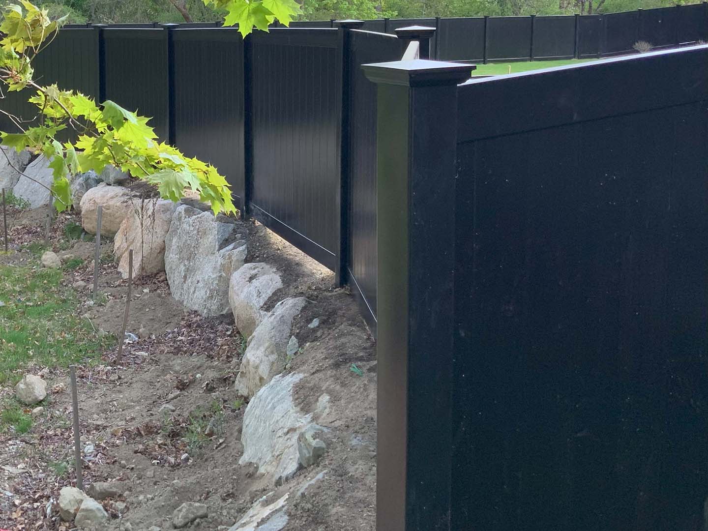 White vinyl privacy fence enclosing a back yard, Merrimack Valley MA