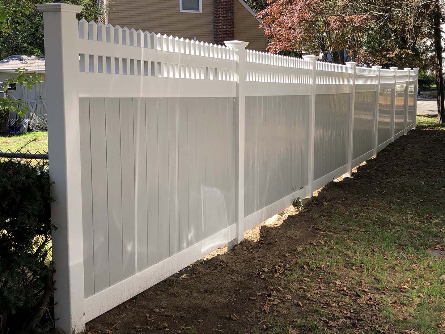 Completed vinyl fence installation for a satisfied customer in the Merrimack Valley
