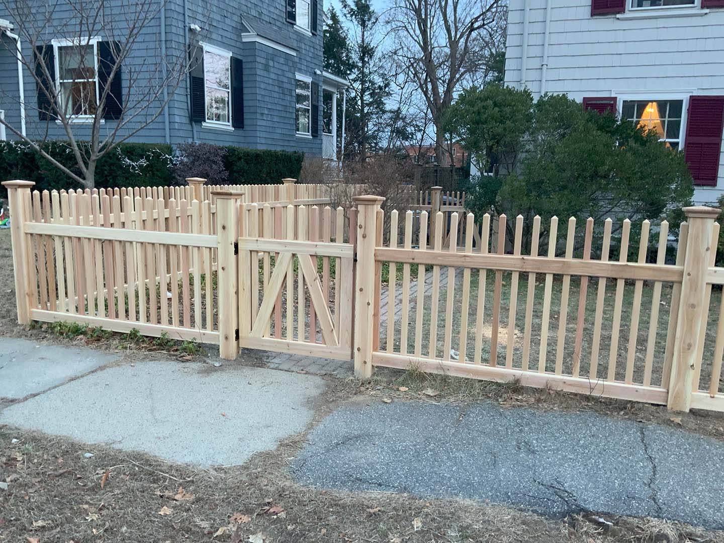 Post and rail farm fencing installed along a rural property line in the Merrimack Valley