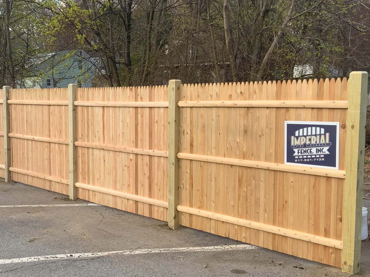 Cedar privacy fence installed along a landscaped back yard in the Merrimack Valley